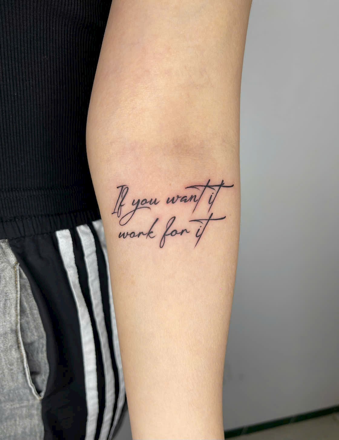 Motivational script forearm tattoo — Rae Ink Saigon