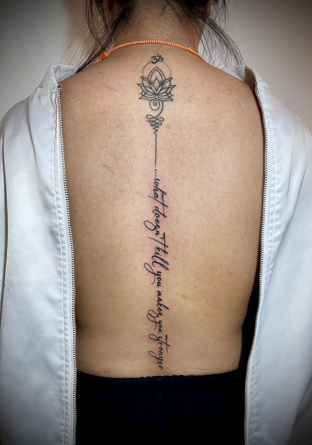 Spine script with lotus blossom fine line tattoo — Rae Ink Vietnam