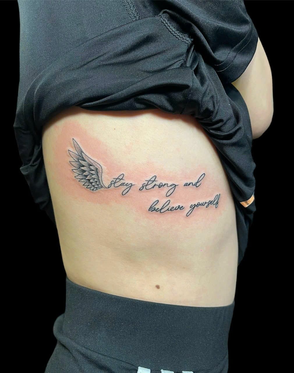 Angel wing with fine line script ribs tattoo — Rae Ink Ho Chi Minh