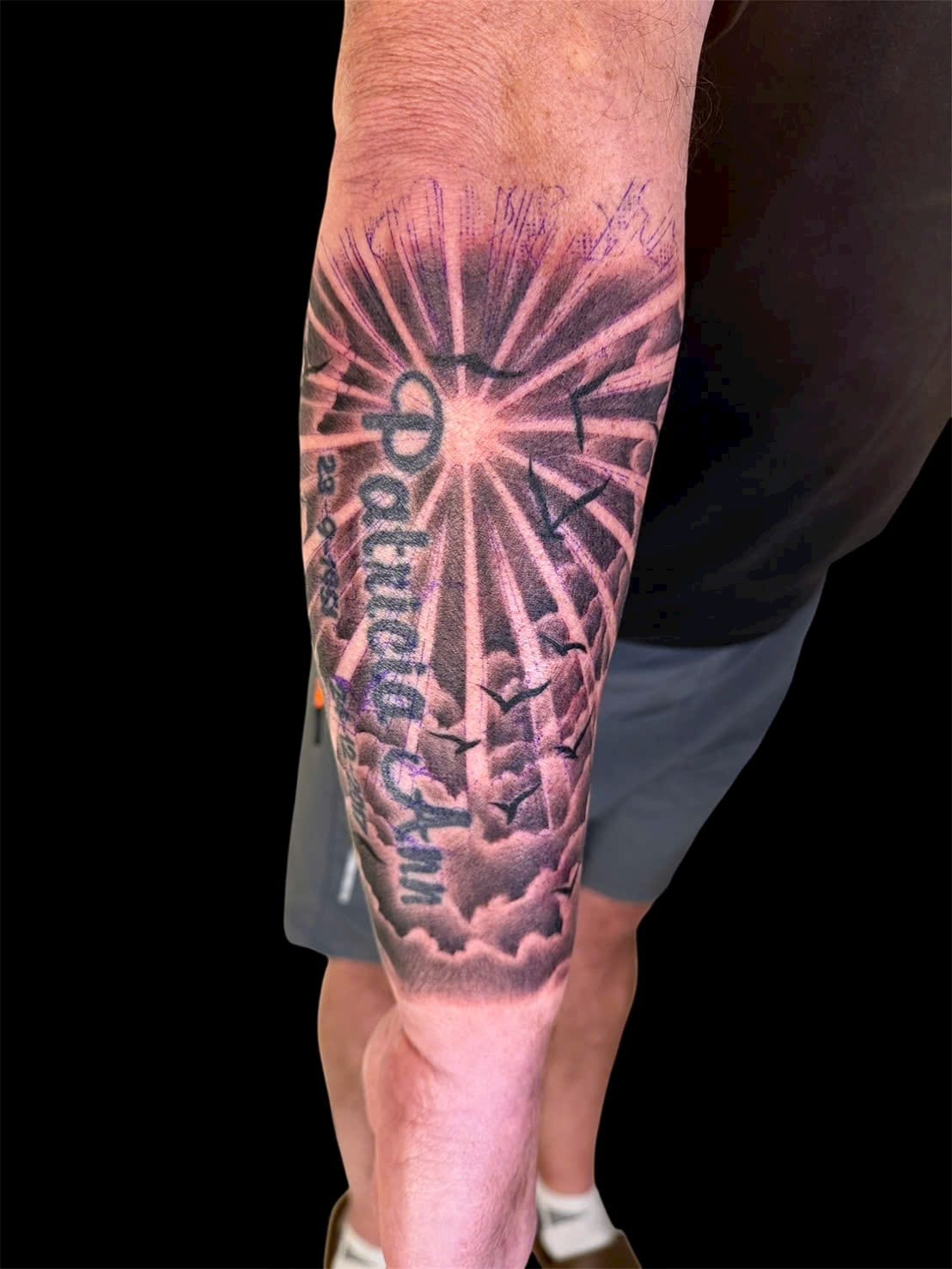 Memorial sun rays and clouds forearm tattoo — Rae Ink Saigon